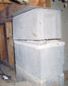 Concrete crawl space support posts in Hammond that are showing signs of failure as they sink into the earth.