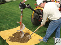 Auguring a hole in the earth for a foundation repair in Warsaw