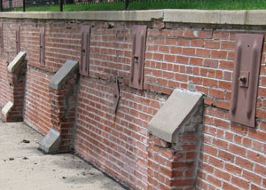 Rusted wall plate anchors in a retaining wall repair in Lowell.