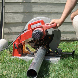 Cutting the support beam for a crawl space jack post outside a Michigan City home.