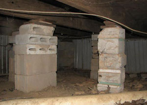 crawl space repairs done with concrete cinder blocks and wood shims in a Hammond home