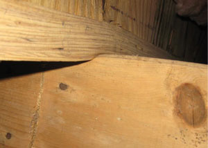 A failing girder showing signs of compression damage in a Angola home