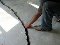 a severely damaged cracked concrete slab floor in Plymouth