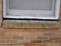 A window sill cracking and separating from the foundation wall in a Munster home.