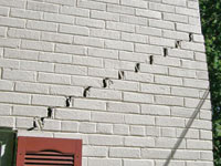 Stair-step cracks showing in a home foundation in Columbia City