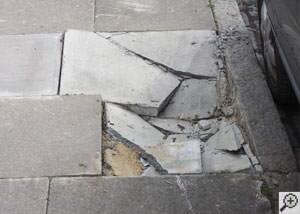 photo of a sinking concrete sidewalk with cracks in Columbia City