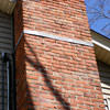 A tilting chimney on a New Haven home with a leaning, tilting chimney that was temporarily repaired.