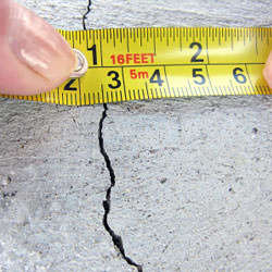 A crack in a poured concrete wall that's showing a normal crack during curing in Auburn