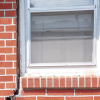 A gap in a window along the outer wall due to foundation settlement of a Hobart home.