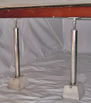 Crawl space jack posts installed in conjunction with a crawl space vapor barrier in Kendallville