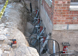 Foundation push piers installed around a house with a foundation settlement issues in Kendallville