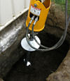 Installing a helical pier during a foundation repair in Elkhart