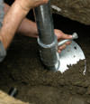 Elkhart helical pier installation nearing completion, with the blade being advanced into the foundation soils.