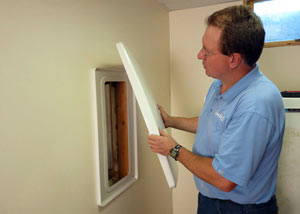 Foundation wall anchor covers installed in a finished basement with a repaired foundation wall in Kendallville.