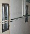 Foundation wall anchor plates installed in a basement in Gary