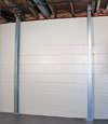 A steel i-beam system installed on a Rochester foundation wall