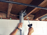 Straightening a foundation wall with the PowerBrace™ i-beam system in a La Porte home.