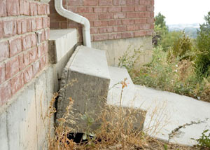 A sinking front step and cracked concrete sidewalk in South Bend.