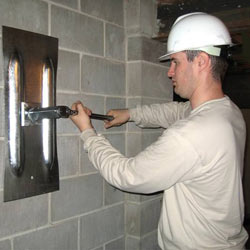 installing a wall anchor to repair an bowing foundation wall in La Porte