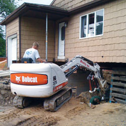 Excavating to expose the foundation walls and footings for a replacement job in Portage