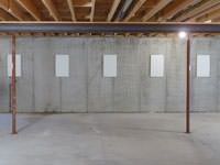 A repaired basement wall with foundation wall anchor covers installed in Crown Point.