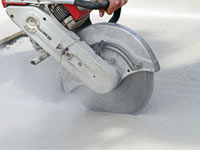 Cutting the driveway for expansion joints during street creep repair in Granger