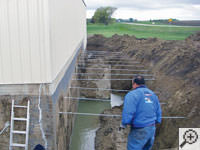 Drilling the hole in the foundation wall for street creep repairs in Columbia City