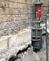 A completed installation of foundation push piers lifting a foundation in Granger