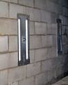 an inside view of foundation wall anchors installed along a basement wall to brace and repair the structure in Hobart